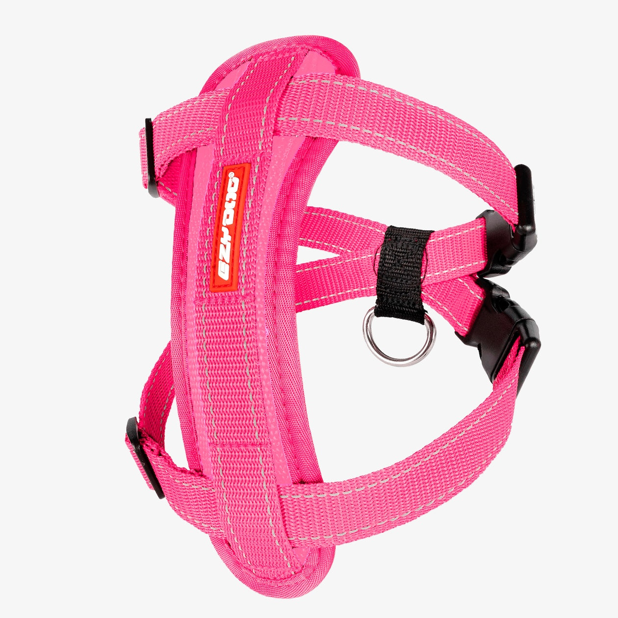 A pink Chest Plate Dog Harness with adjustable straps, a metal ring, and a label showing the brand name.