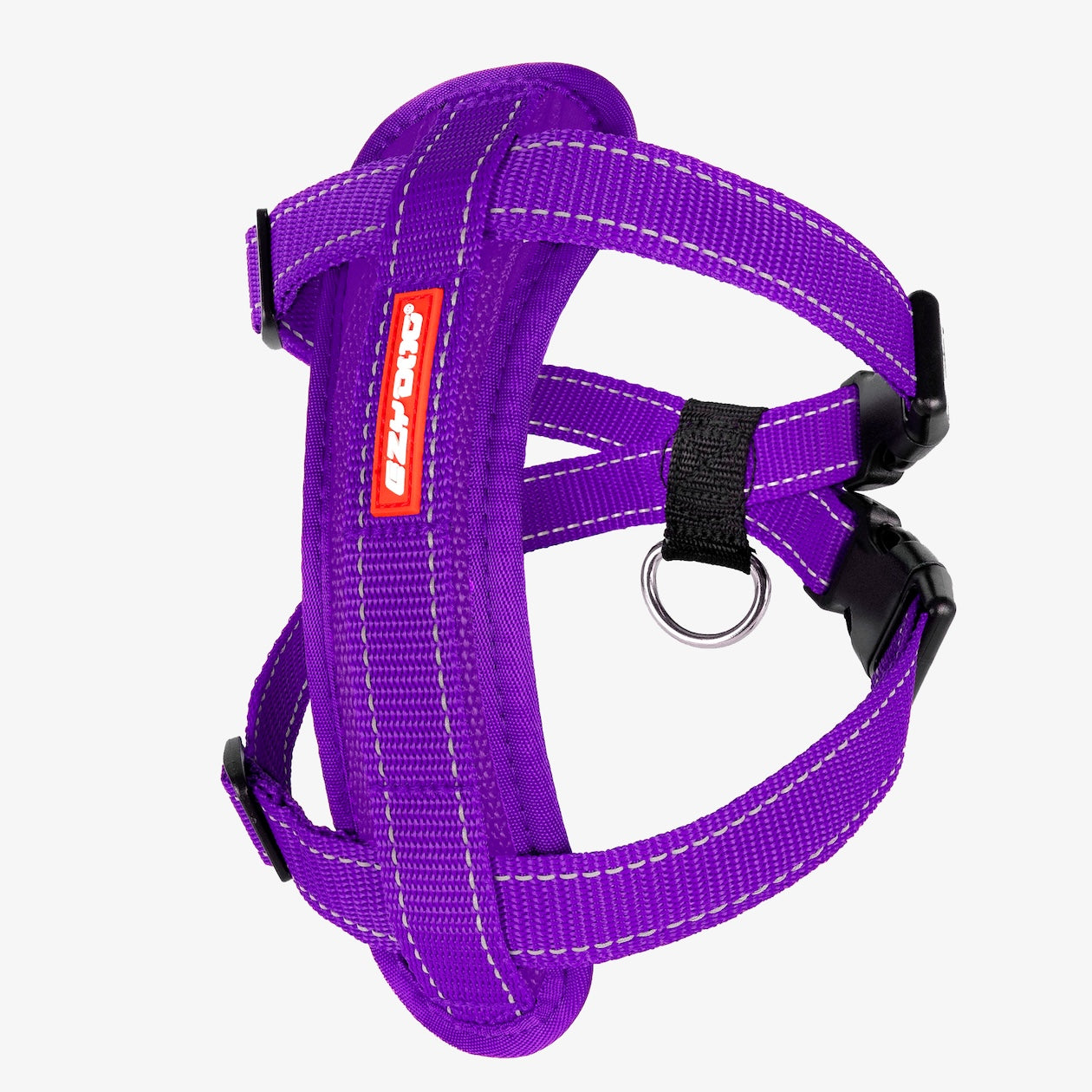 A purple Chest Plate Dog Harness with adjustable straps, a metal ring, and a label showing the brand name.