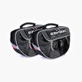 A black dog backpack with the EzyDog brand logo, featuring a large main compartment and a quick-access front section, with reflective trim for safety.