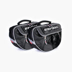A black dog backpack with the EzyDog brand logo, featuring a large main compartment and a quick-access front section, with reflective trim for safety.