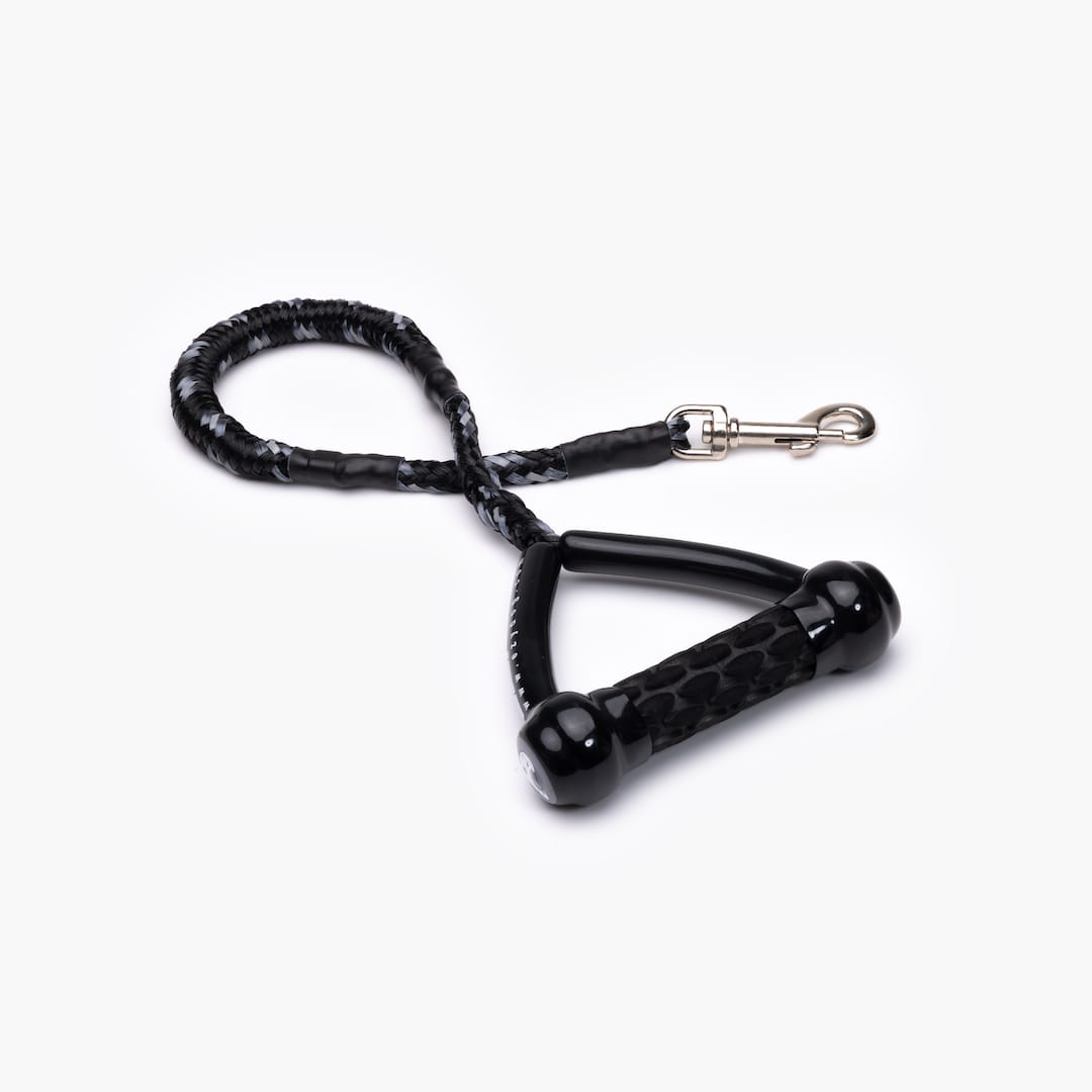 A black and gray shock-absorbing dog leash with a handle and metal clasp.