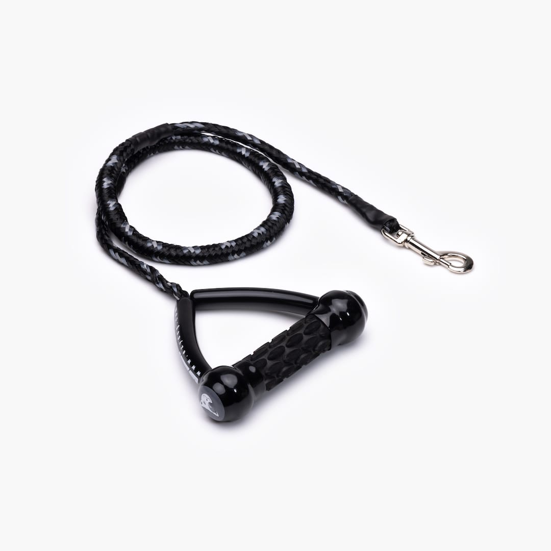 A black and gray shock-absorbing dog leash with a handle and metal clasp.