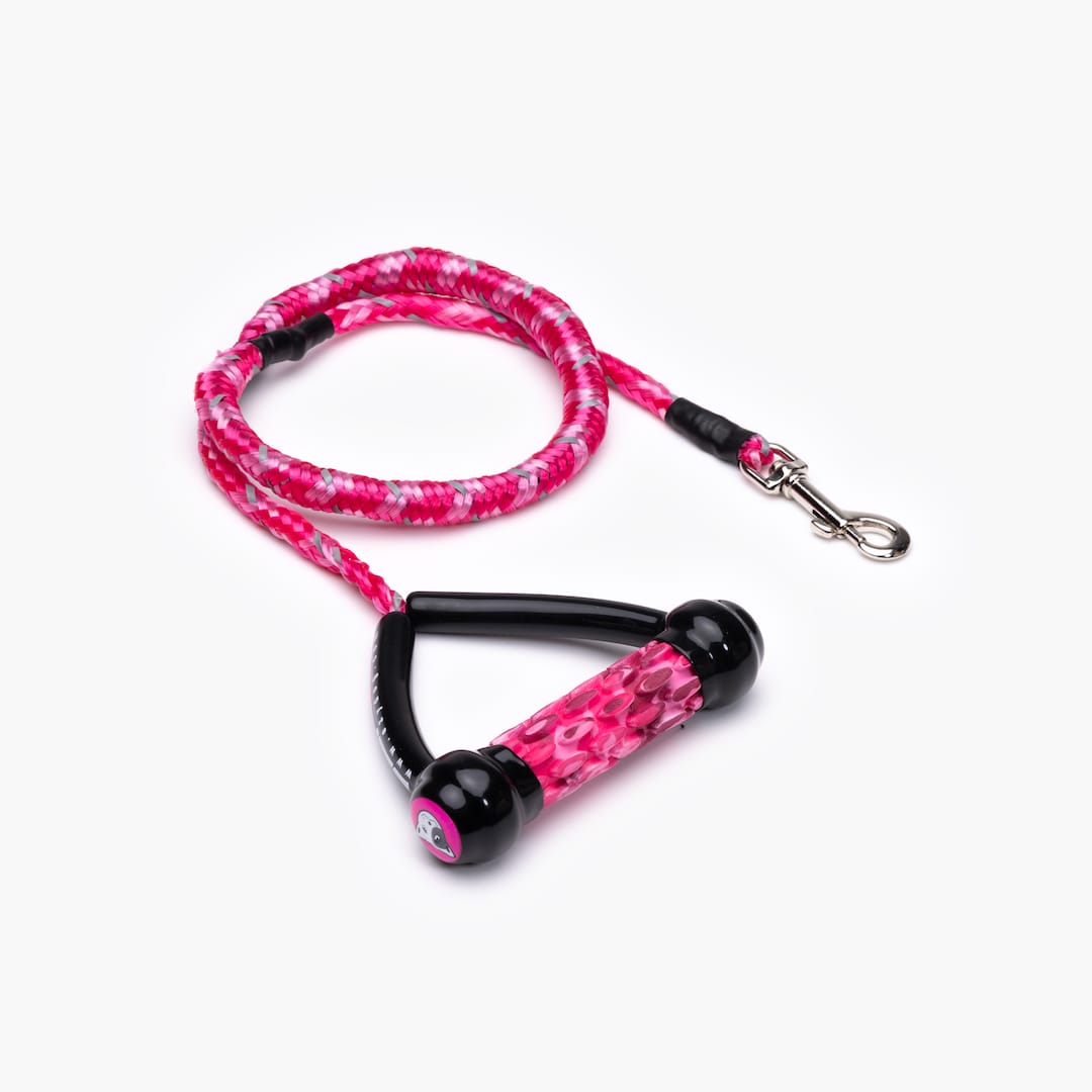 A pink shock-absorbing dog leash with a handle and metal clasp.
