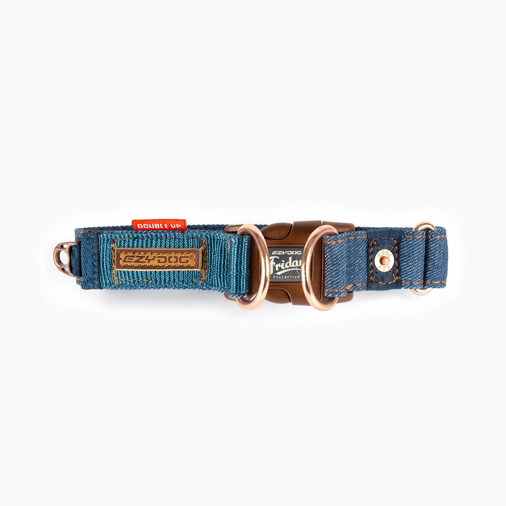 Dog collar with blue fabric and brown leather accents on a white background.