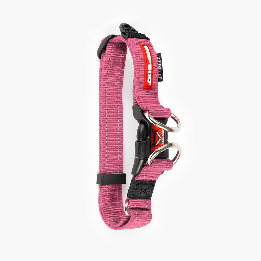 Pink dog collar with black and silver hardware on a white background.