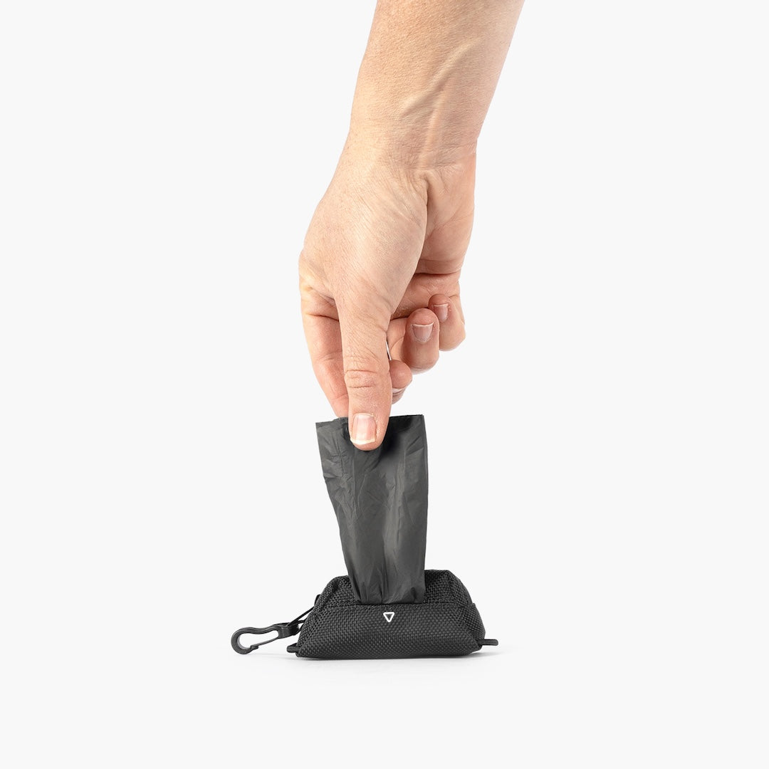 Dog poop bag pulled from the EzyDog Essential Poop Bag Holder