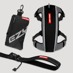 Black and gray dog harness with red label on a light gray background