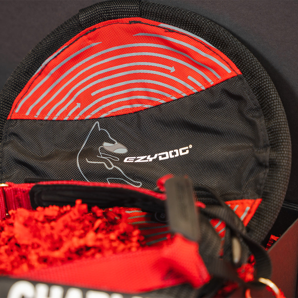 Red and black pet product with EzyDog branding on a dark background
