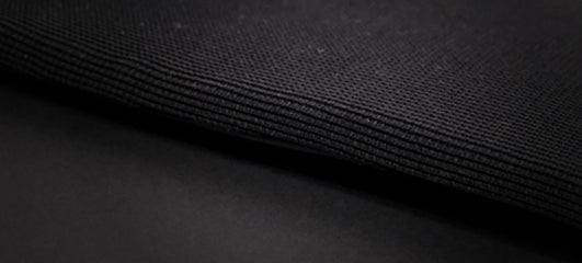 Close-up of the textured black fabric used in an EzyDog harness, showcasing its durable material.