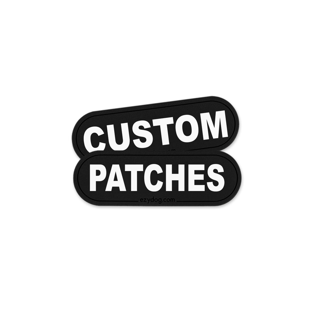 Two black rounded rectangular patches with white text reading 'CUSTOM PATCHES' on a plain white background.