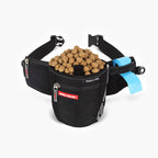 A black EzyDog SnakPak Pro treat belt filled with dog treats, featuring a poop bag dispenser and twin magnetic closures.