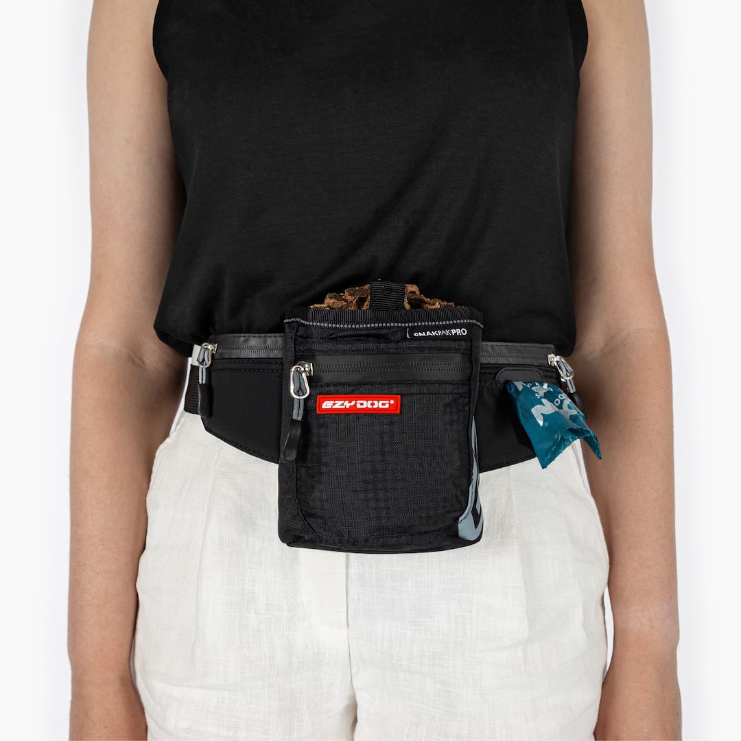 Person wearing a black waist bag with visible branding on a white background