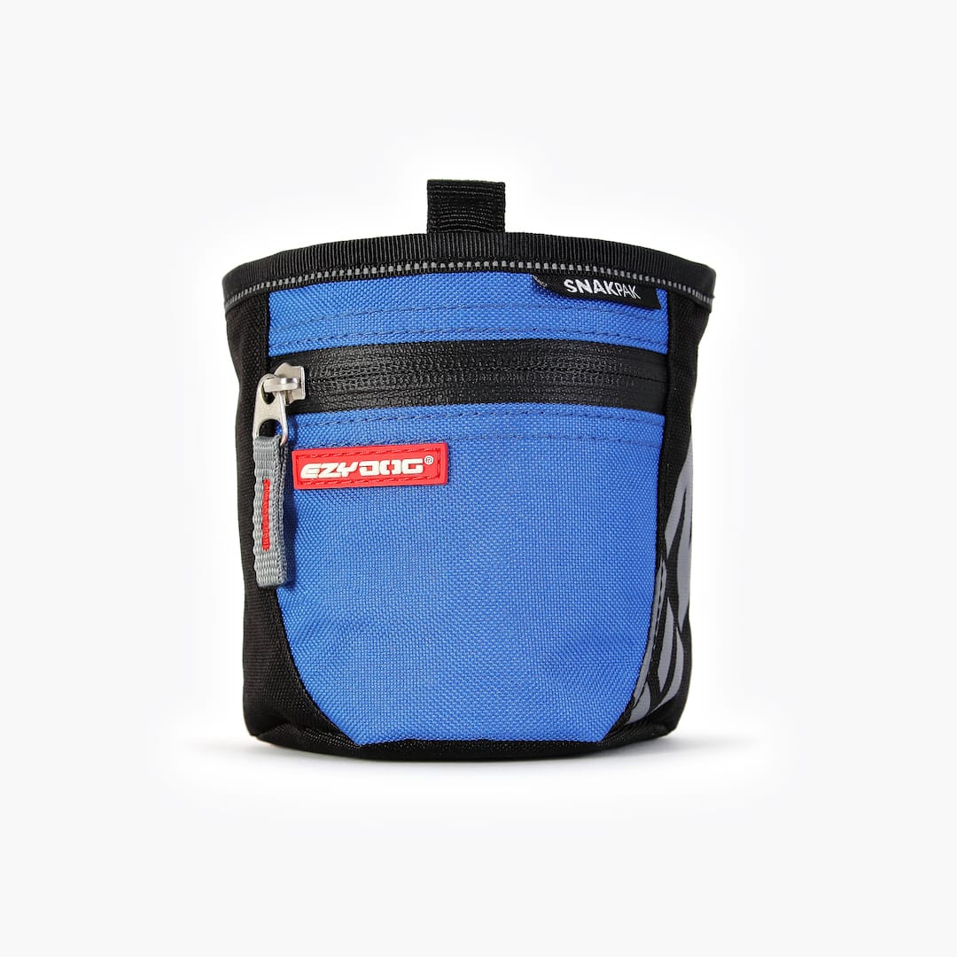 A blue SnakPak dog treat bag with magnetic closures and adjustable straps.