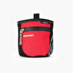 A SnakPak dog treat bag in red with magnetic closures and adjustable straps.