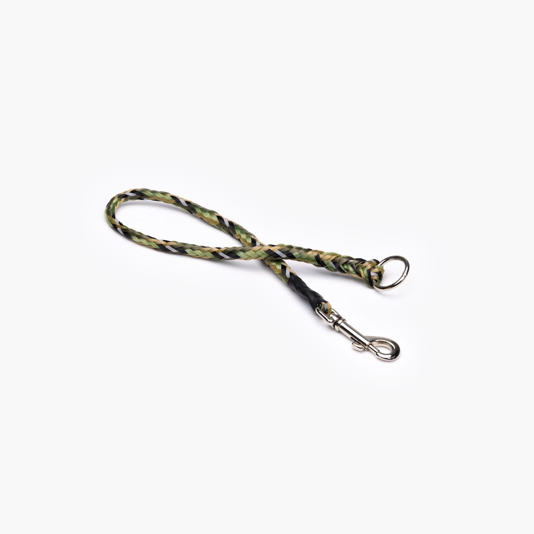 A black and green bungee leash extension with a metal clasp on each end, isolated on a white background.