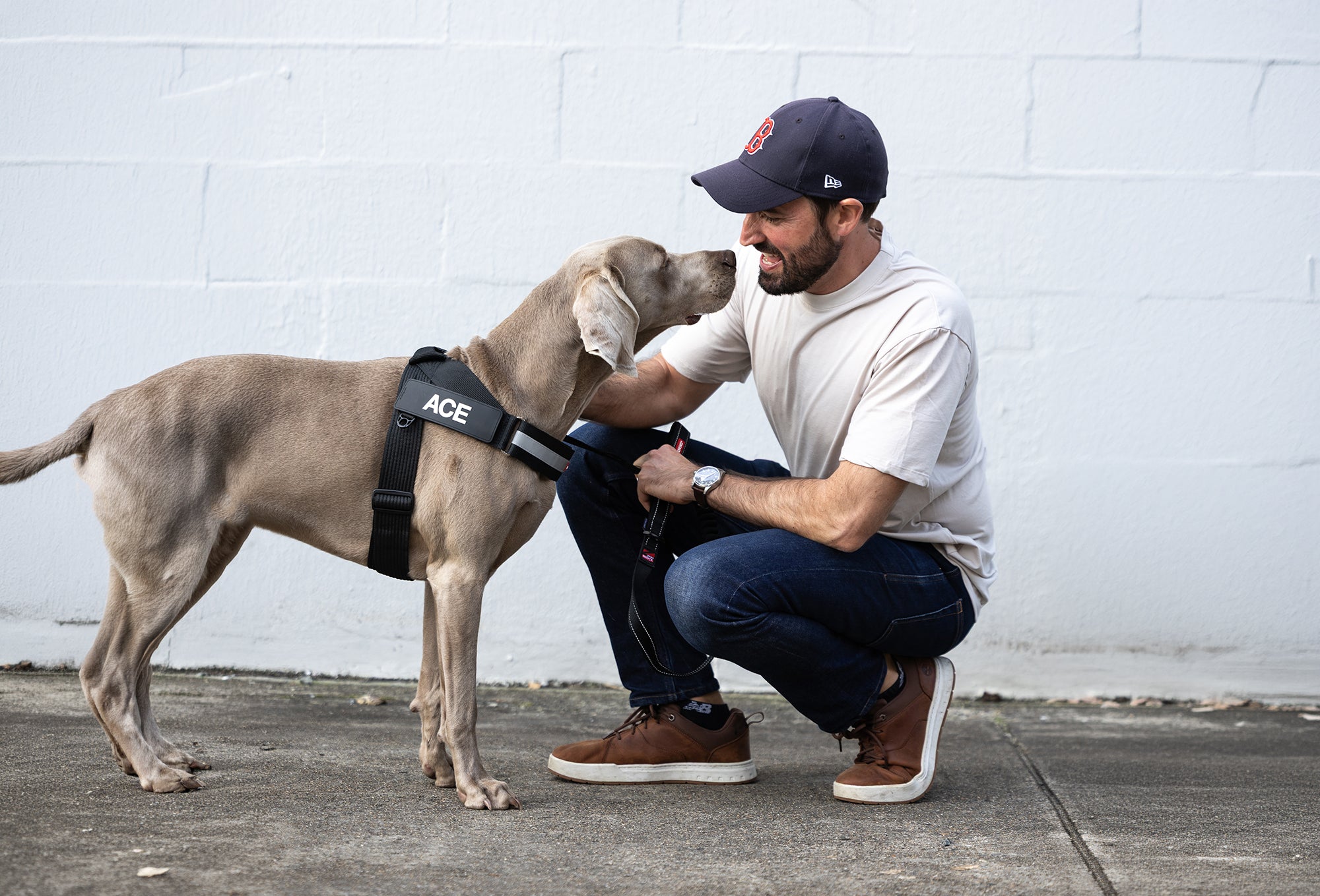 A man and his dog look at each other with endearing excitement