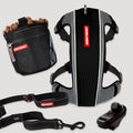 Dog training equipment including a harness, leash, and clicker on a light gray background.