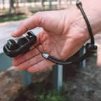 a person holding a hands-free dog training clicker